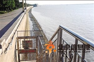 虽然钱塘江边堤坝被铁门封锁，但不少人仍不顾警告下水游玩 图片来源：网友微博