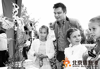 图为阿拉木图市民观赏中国传统糖画工艺。本报记者