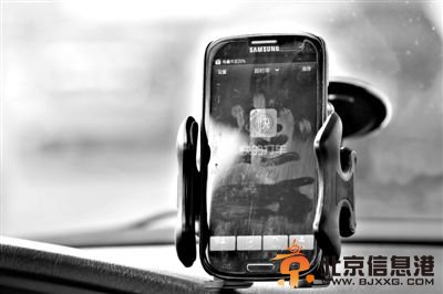 2月17日,一出租车司机将装有“快的”打车软件的<a href='http://www.bjxxg.cn/tech/shouji/' target='_blank'><u>手机</u></a>固定在车前。新京报记者 尹亚飞 摄
