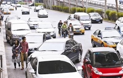 　双安商场附近道路乱停车现象有所缓解，但仍然有众多占道车摄影 本报记者 袁艺
